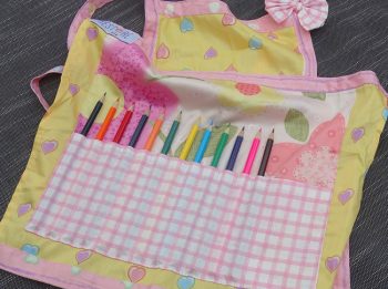 Childs apron with pencils in yellow