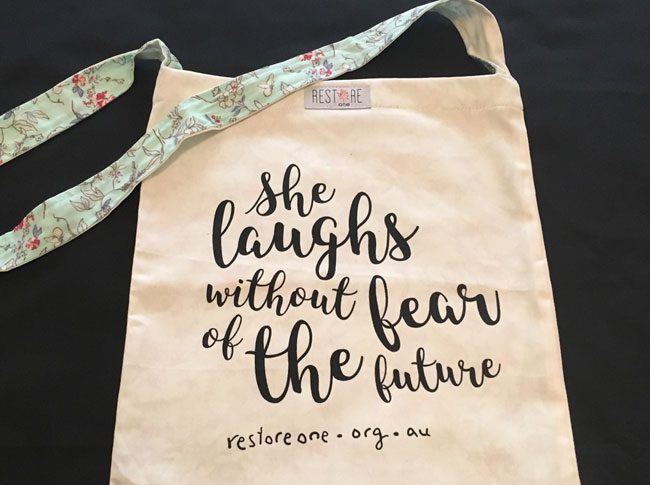 Tote bags She Laughs Without Fear